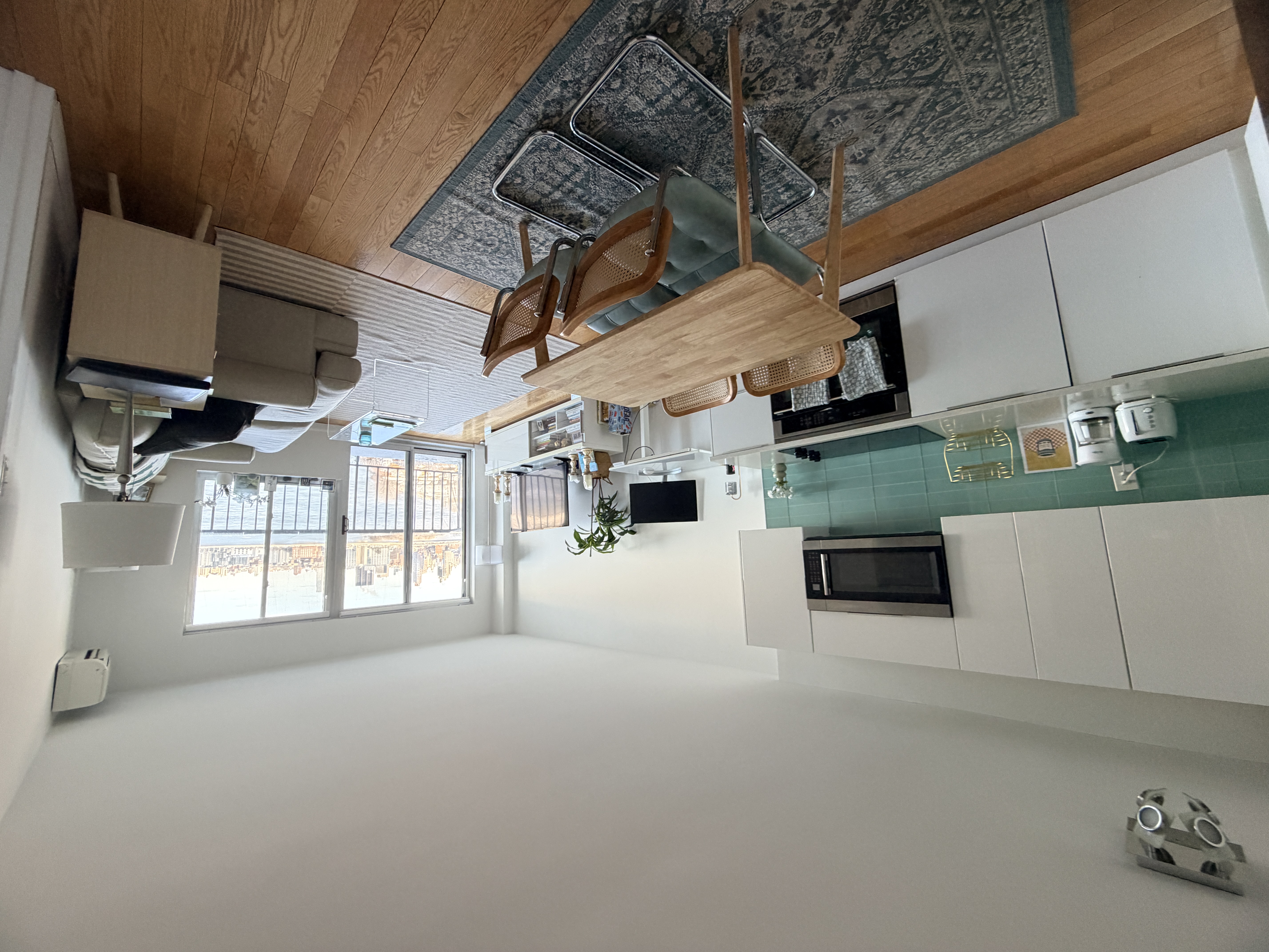 25-40 Shore Boulevard, Unit 15T Queens, NY 11102 - Photo 6 of 24 a living room with furniture and a wooden floor