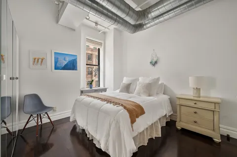 a bedroom with a bed and a chair