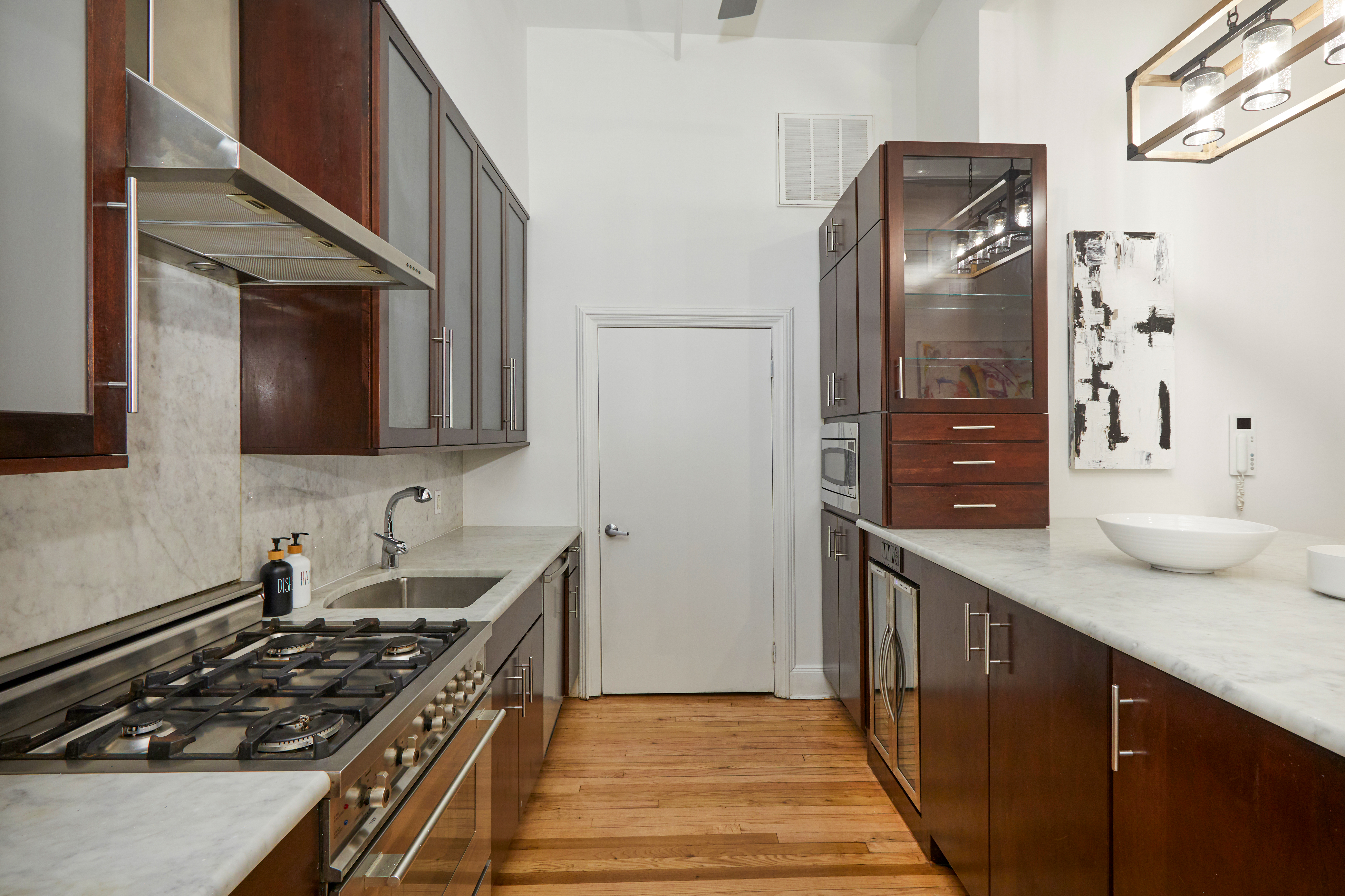 80 Leonard Street, Unit 3G Manhattan, NY 10013 - Photo 16 of 30 a kitchen with stainless steel appliances a stove and a refrigerator