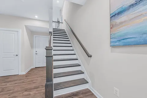 a view of entryway and hall with wooden floor