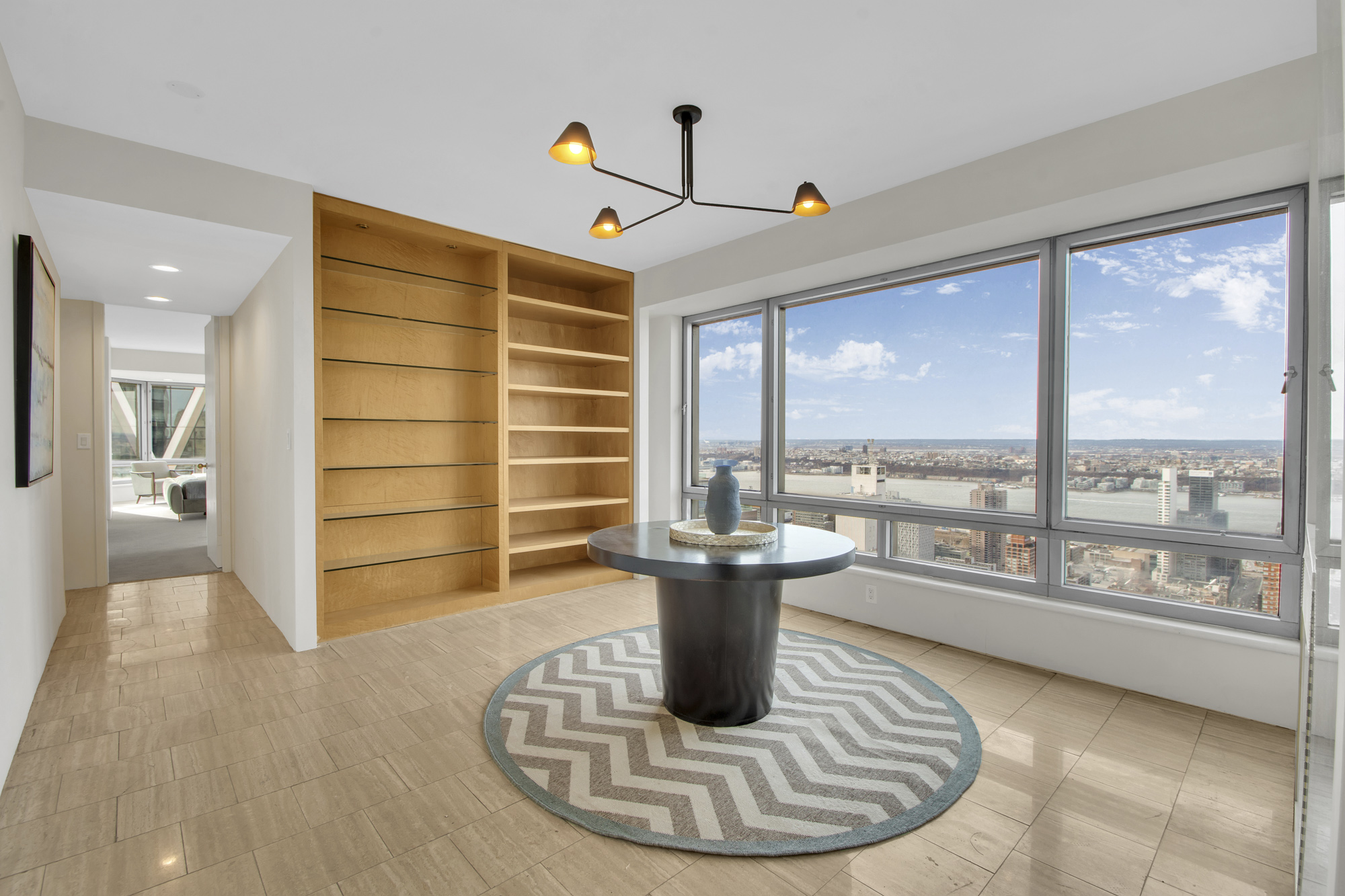 301 West 57th Street, Unit 48A Manhattan, NY 10019 - Photo 12 of 22 a living room with furniture and a large window