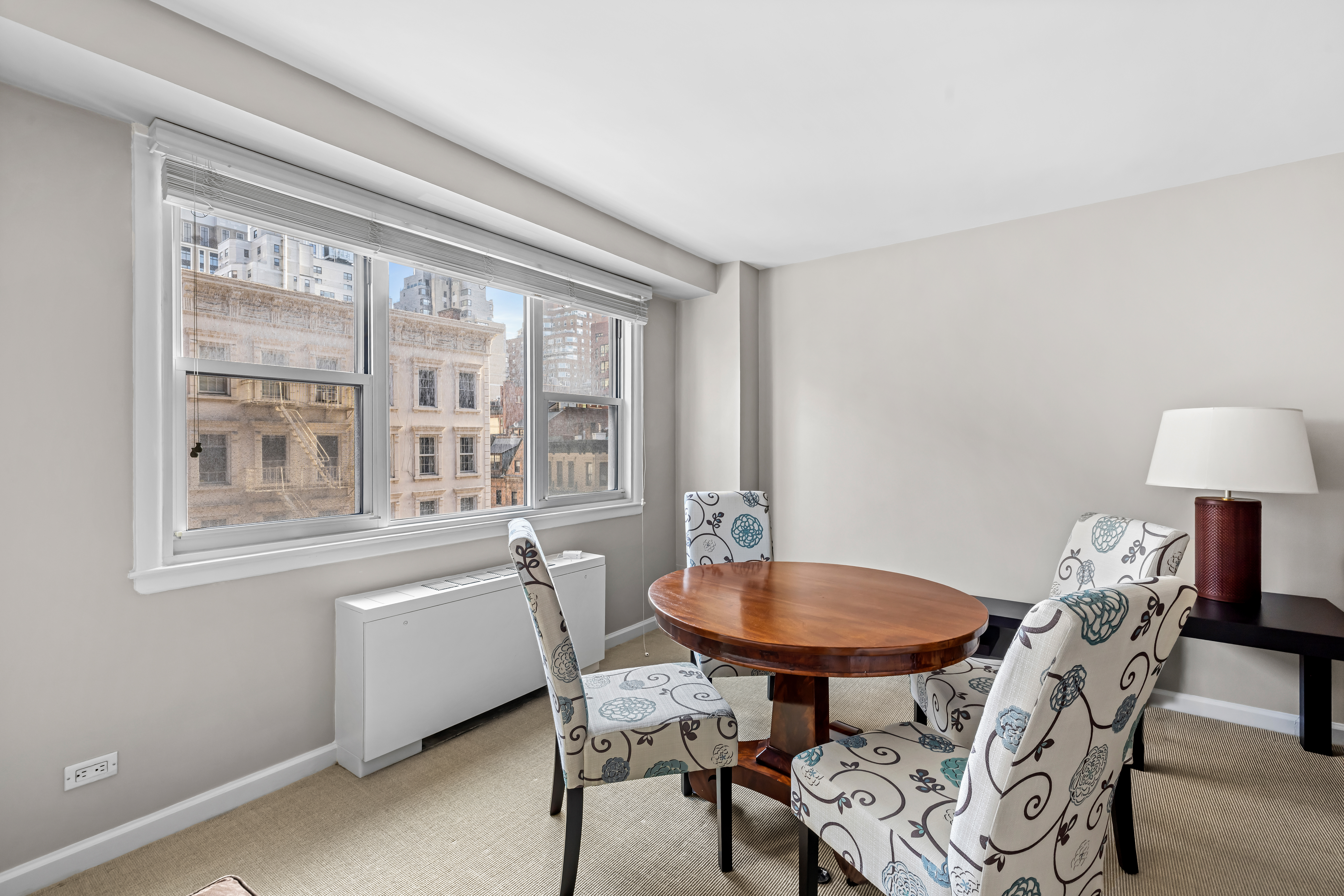 123 East 75th Street, Unit 5C Manhattan, NY 10021 - Photo 3 of 8 a view of a dining room with furniture and a window