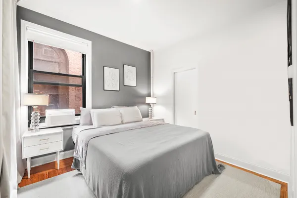 a bedroom with a bed and a window