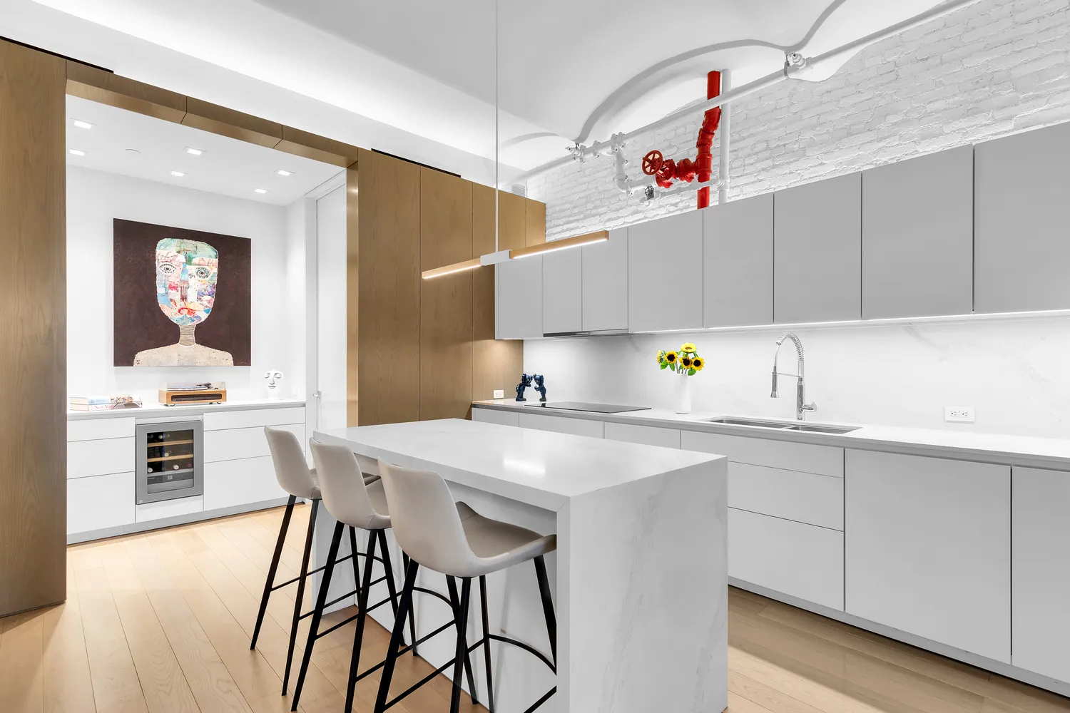 a kitchen with a sink a stove and chairs