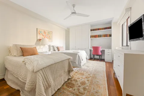 a bedroom with a bed and flat screen tv