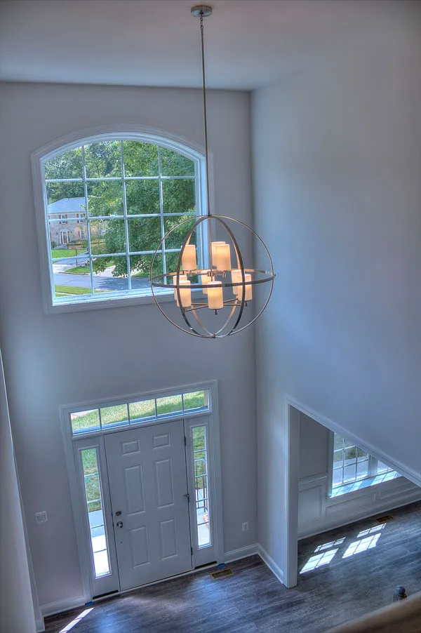 a front view of a house with large windows and a chandelier