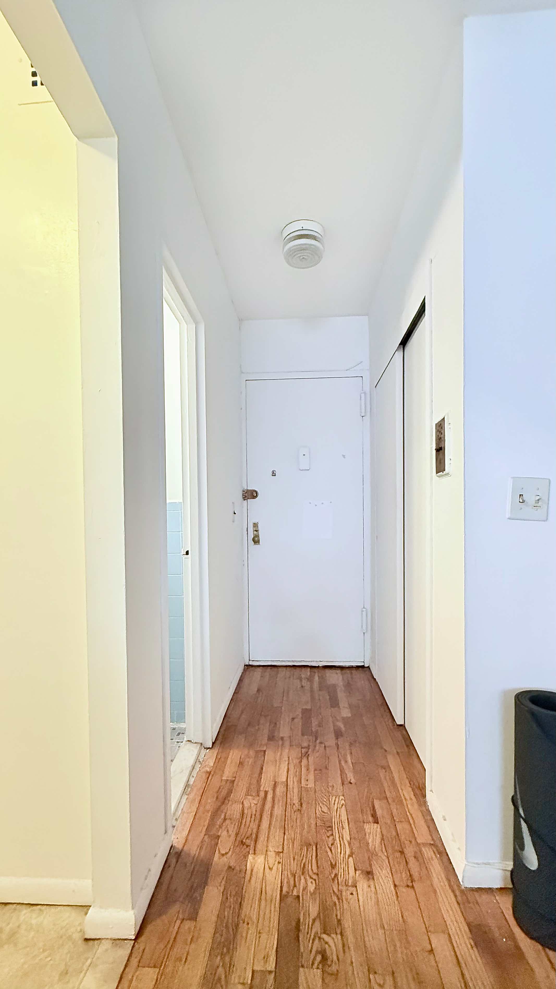 229 East 29th Street, Unit 5H Manhattan, NY 10016 - Photo 7 of 15 a view of a room with wooden floor and a bathroom