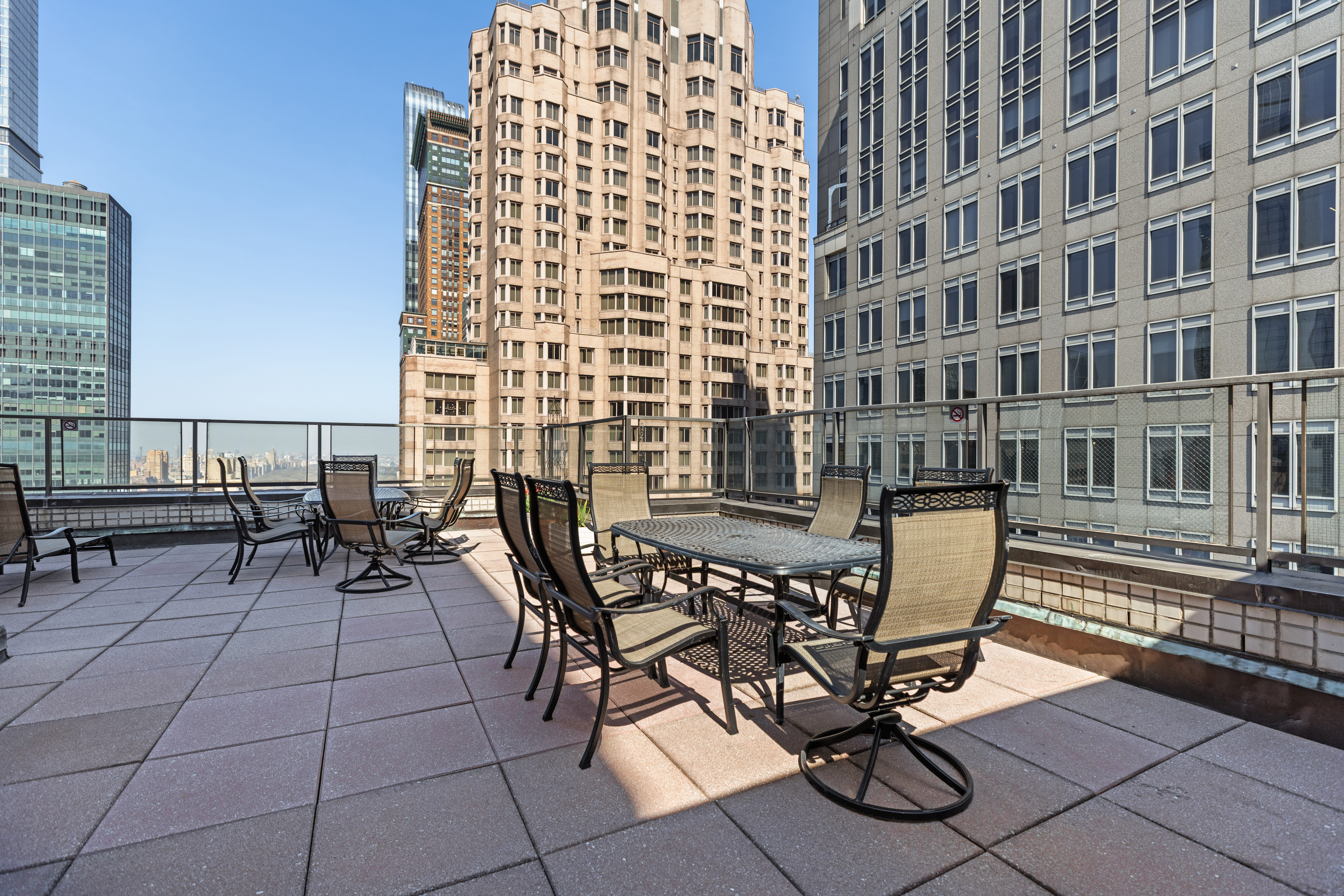 159 West 53rd Street, Unit 31F Manhattan, NY 10019 - Photo 8 of 16 a view of a patio with a table and chairs