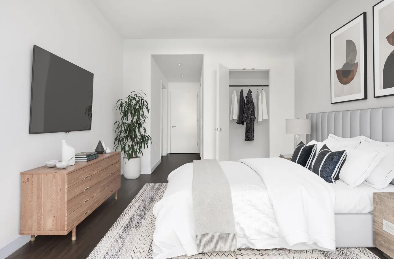 a bedroom with a bed and a flat screen television