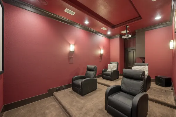 a media room with lots of chairs and a projector screen