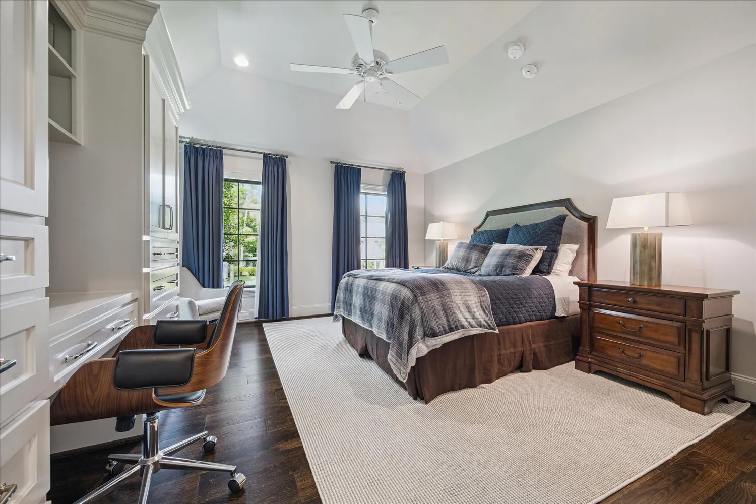 a spacious bathroom with a granite countertop sink a toilet and a shower