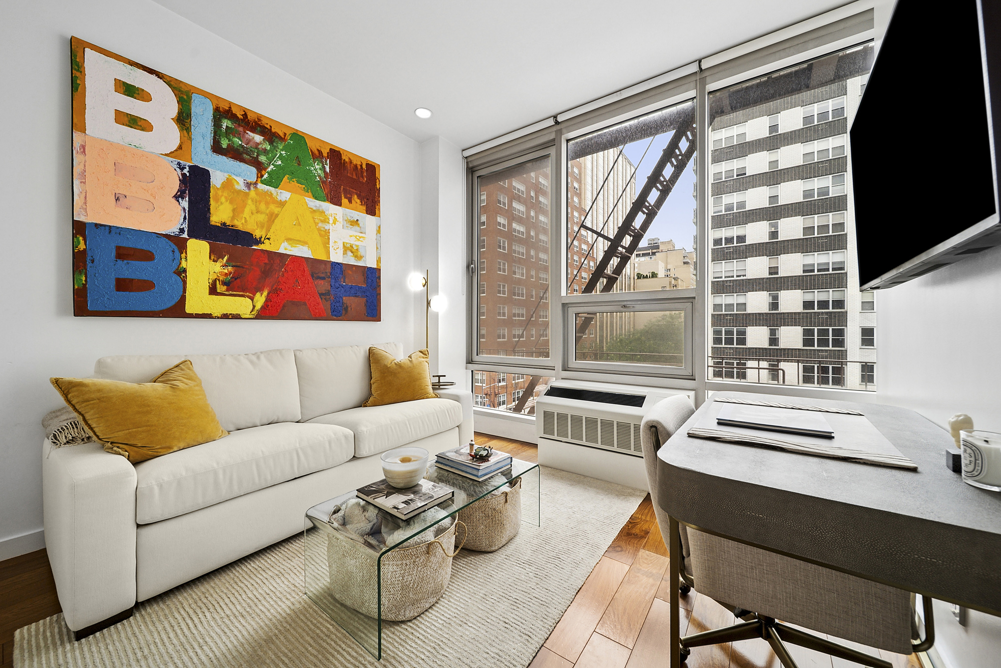 148 East 19th Street, Unit 4B Manhattan, NY 10003 - Photo 7 of 10 a living room with furniture and a flat screen tv