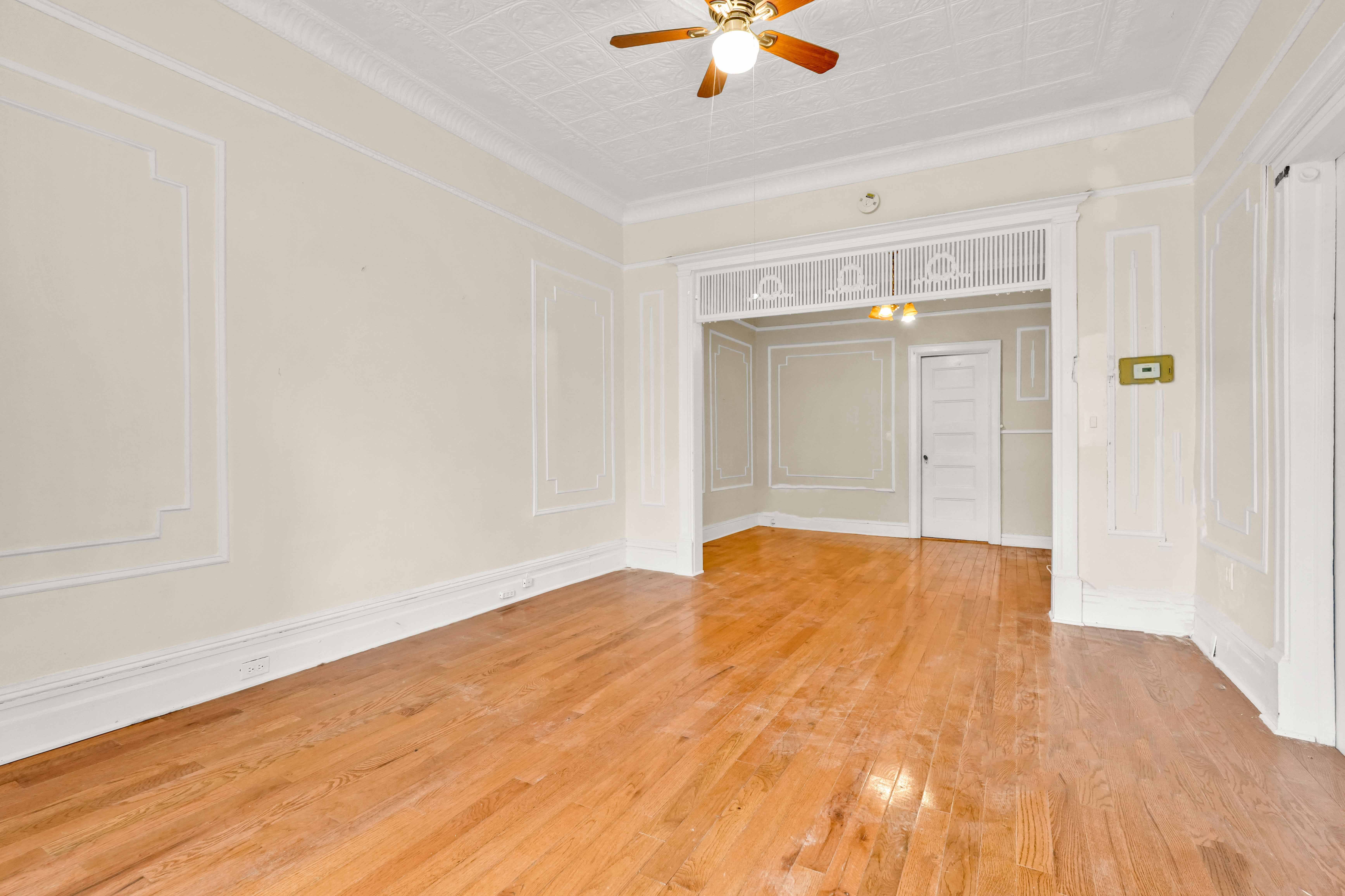 278 Lefferts Avenue Brooklyn, NY 11225 - Photo 28 of 56 a view of an empty room and window with wooden floor