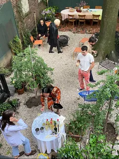 a backyard of a house with lots of green space and a water fountain