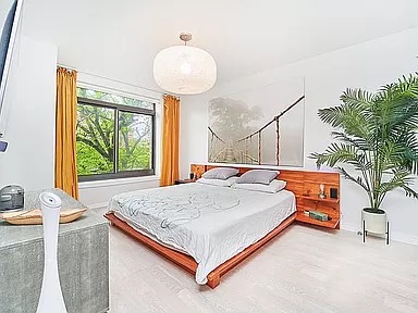 2351 Adam Clayton Powell Jr Boulevard, Unit 306 Manhattan, NY 10030 - Photo 3 of 13 a bed sitting in a bedroom next to a window