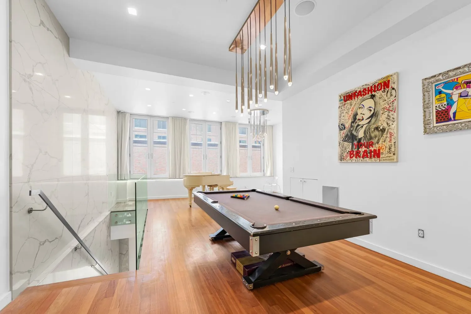 a living room with table tennis pool table and chairs