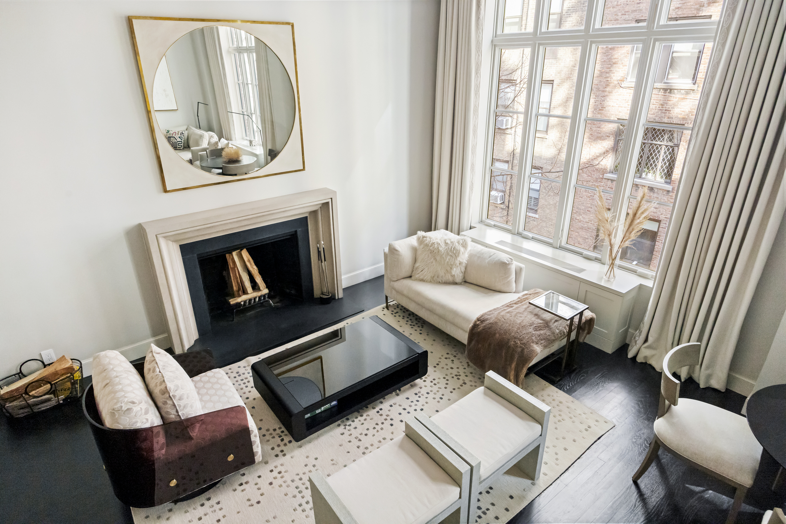 169 East 78th Street, Unit 7C Manhattan, NY 10075 - Photo 9 of 30 a living room with furniture and a fireplace