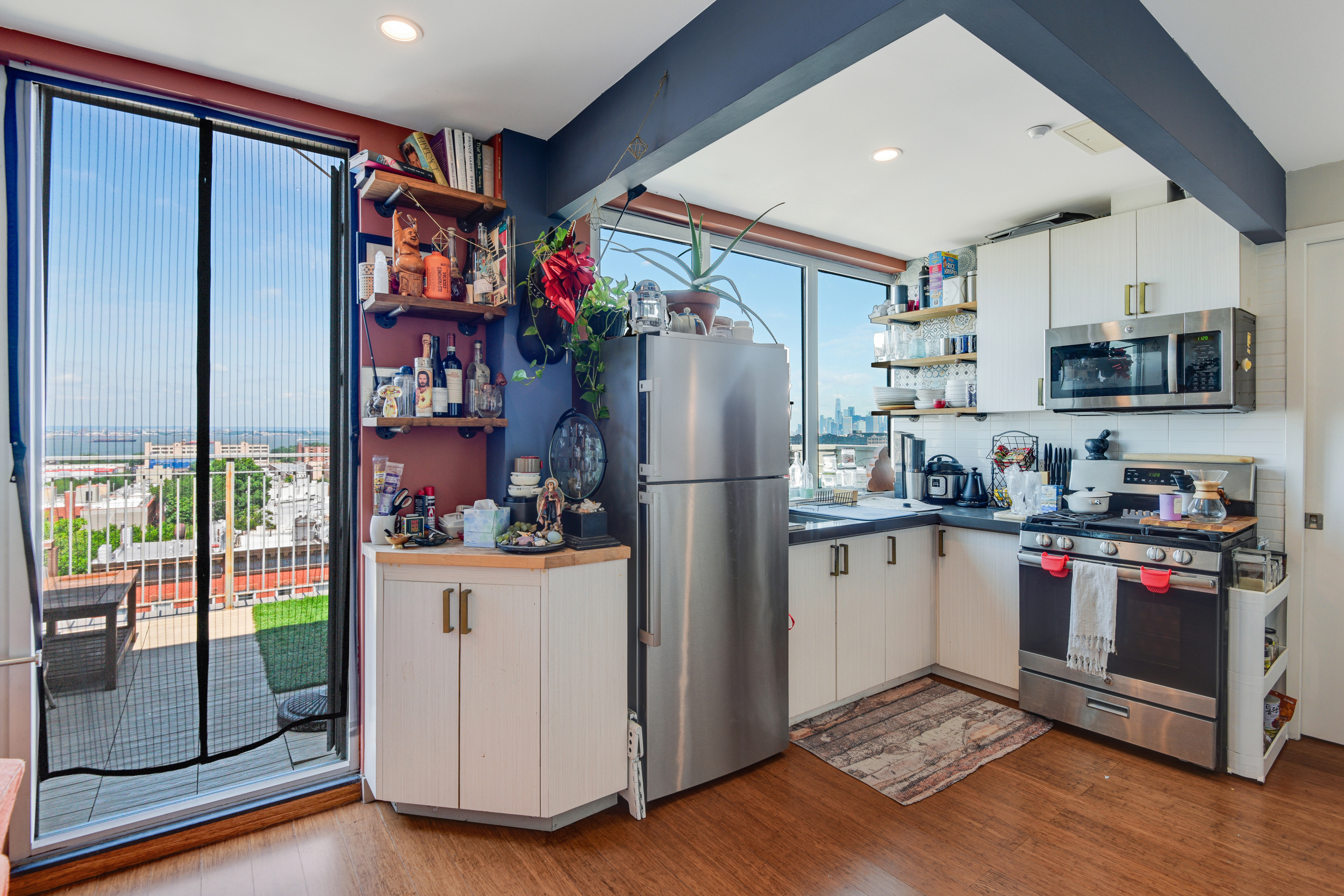 4907 4th Avenue, Unit 7A Brooklyn, NY 11220 - Photo 5 of 13 a kitchen with stainless steel appliances granite countertop a refrigerator and a stove top oven
