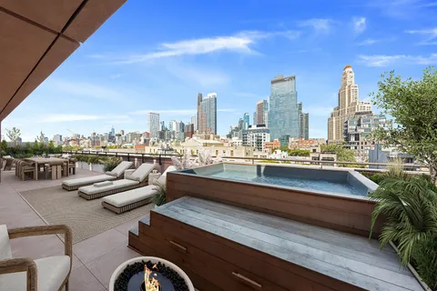 a terrace with outdoor seating city view and barbeque oven