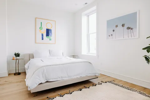 a bedroom with a bed and a window