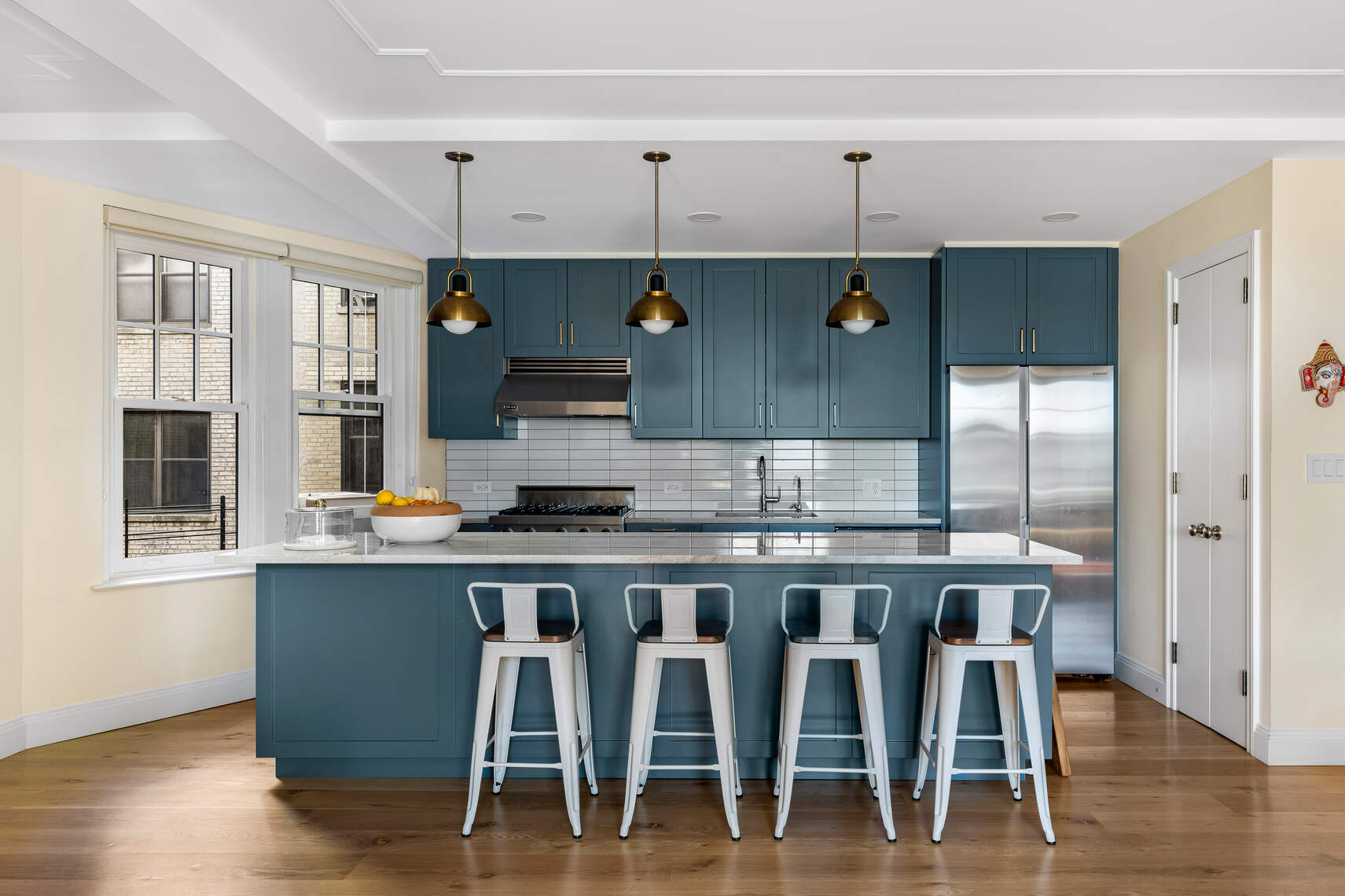 47 Plaza Street West, Unit 5B Brooklyn, NY 11217 - Photo 2 of 14 a kitchen with stainless steel appliances granite countertop a table chairs stove and wooden cabinets