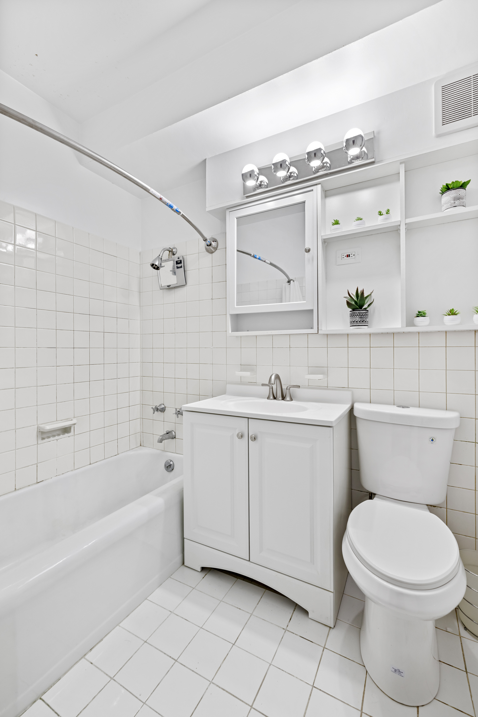 12 Beekman Place, Unit 9D Manhattan, NY 10022 - Photo 7 of 8 a bathroom with a sink a toilet and bathtub