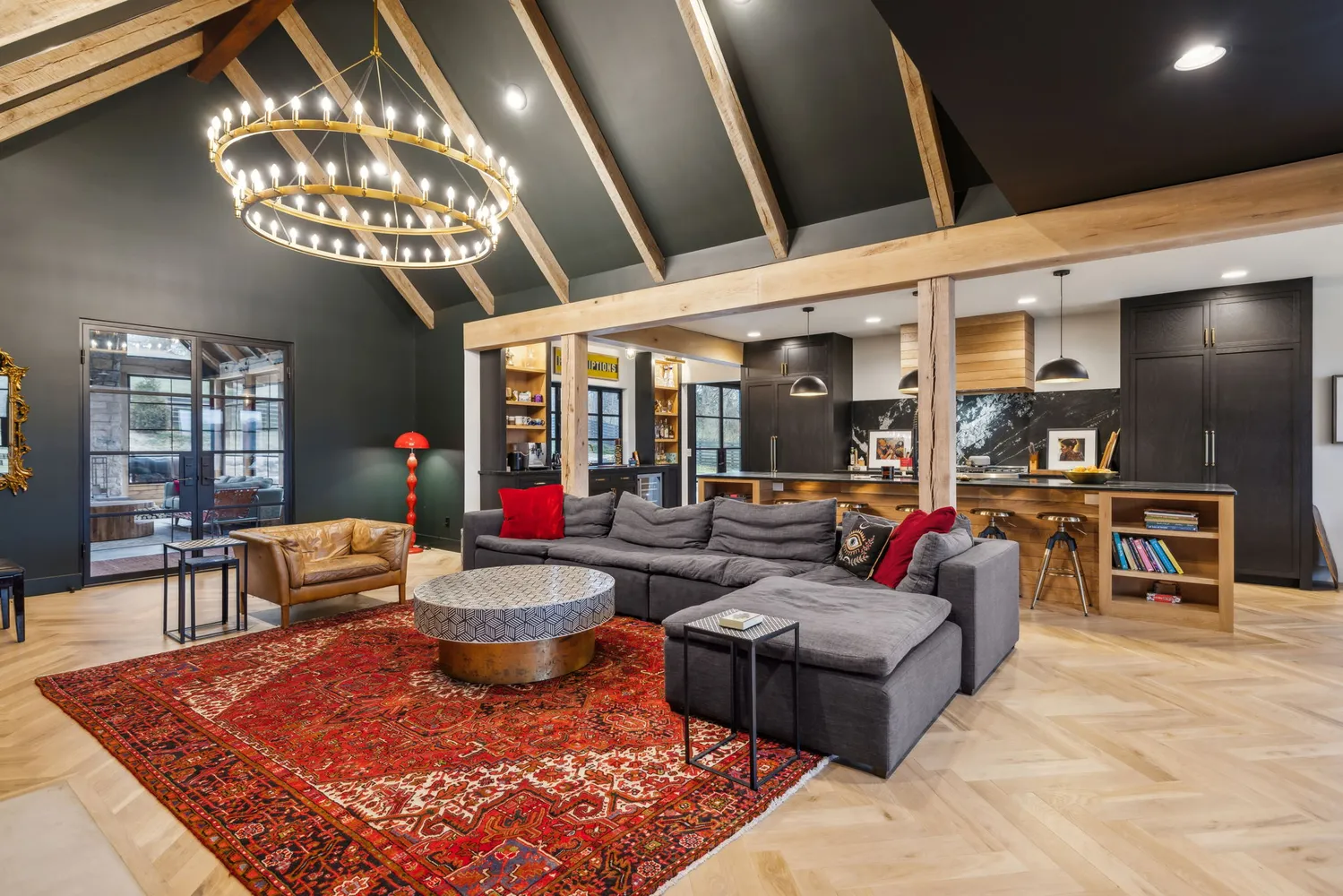 a living room with furniture a chandelier and a dining table