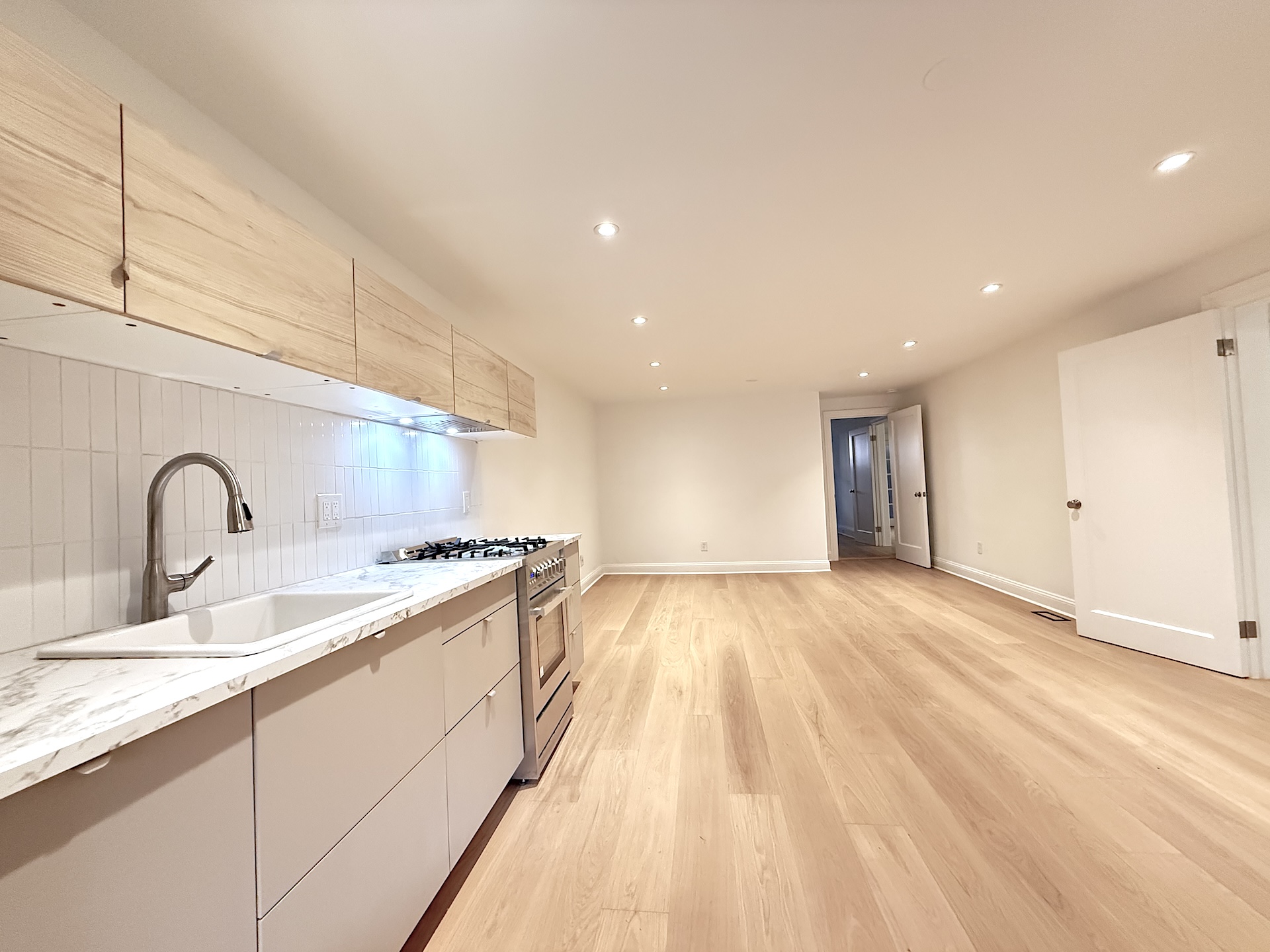 424 Pacific Street, Unit GARDEN Brooklyn, NY 11217 - Photo 3 of 16 a large kitchen with stainless steel appliances granite countertop a sink and a stove