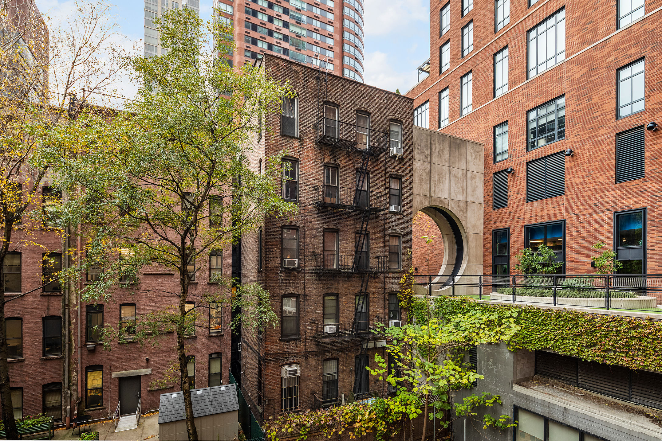 206 East 95th Street, Unit 4B Manhattan, NY 10128 - Photo 4 of 6 a front view of a building with garden