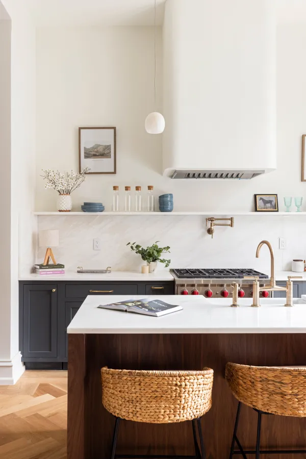 a view of kitchen island with stainless steel appliances granite countertop a sink and a stove