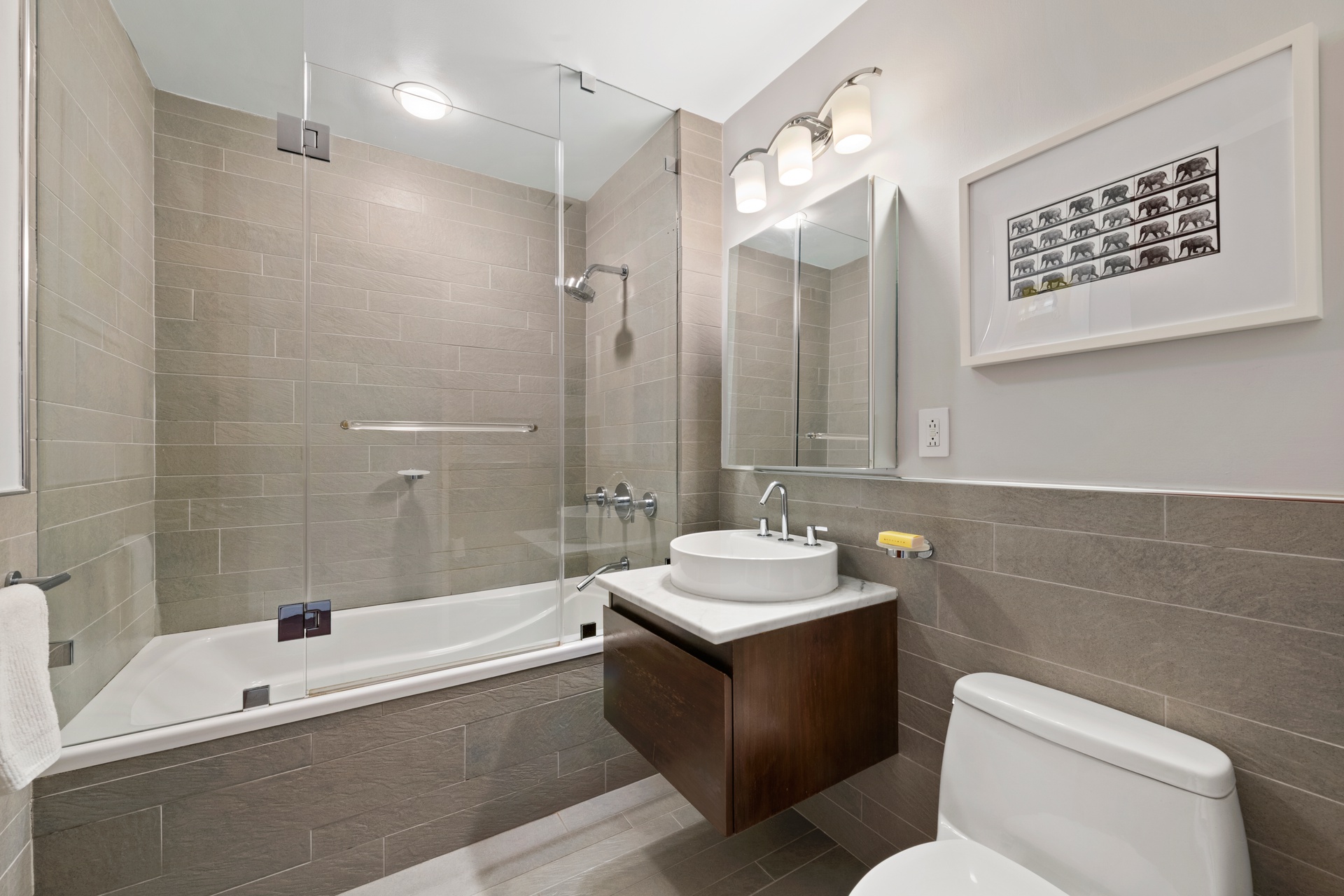 50 West 15th Street, Unit 2D Manhattan, NY 10011 - Photo 9 of 15 a bathroom with a sink a toilet and shower