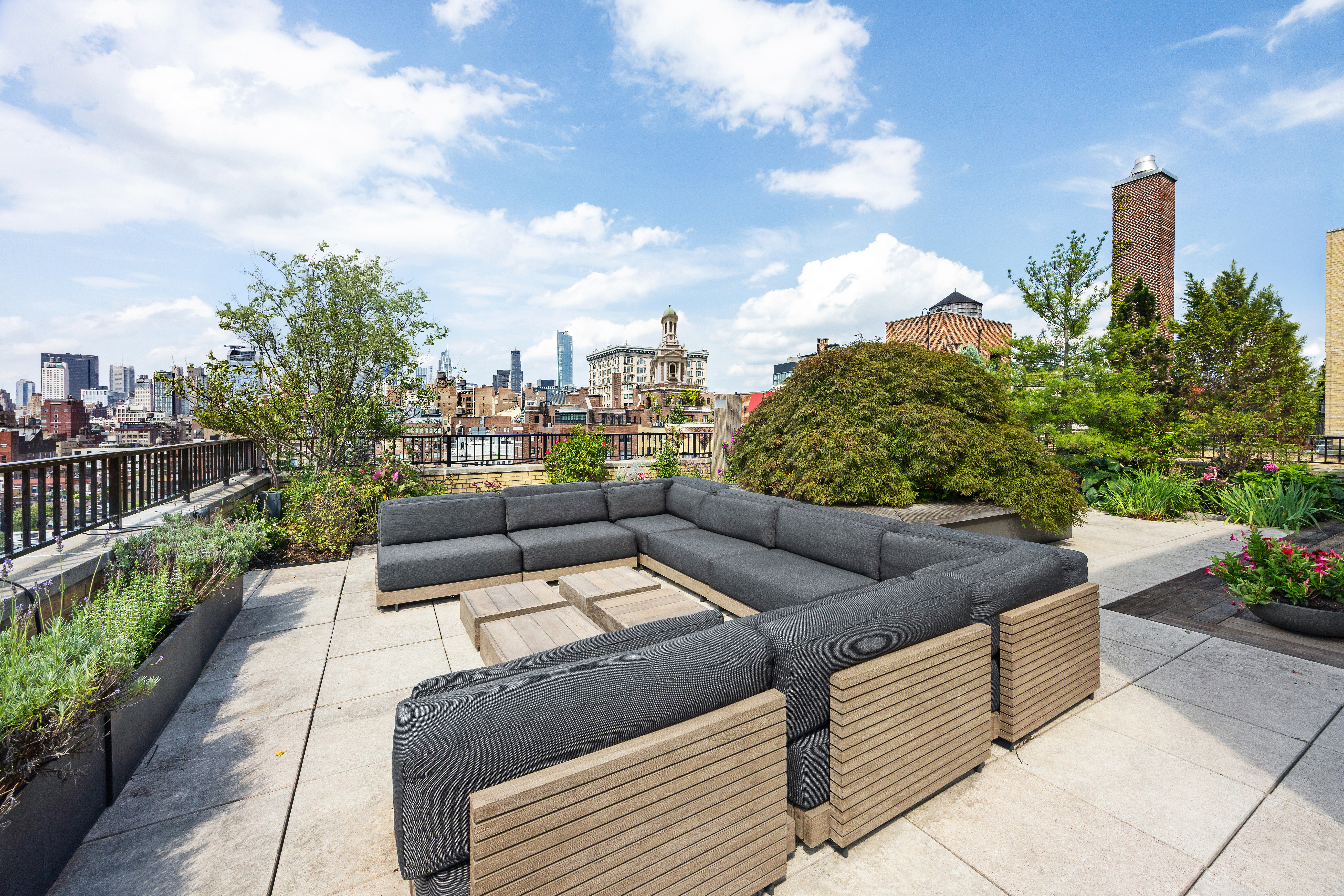 24 5th Avenue, Unit PH1701 Manhattan, NY 10011 - Photo 21 of 24 a view of a terrace with couches and potted plants