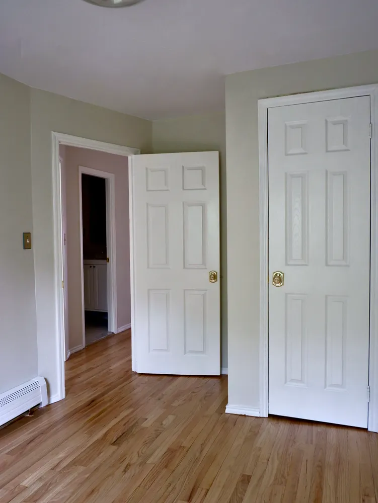 a view of an empty room with wooden floor