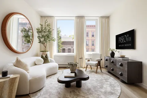 a living room with furniture a flat screen tv and a large window