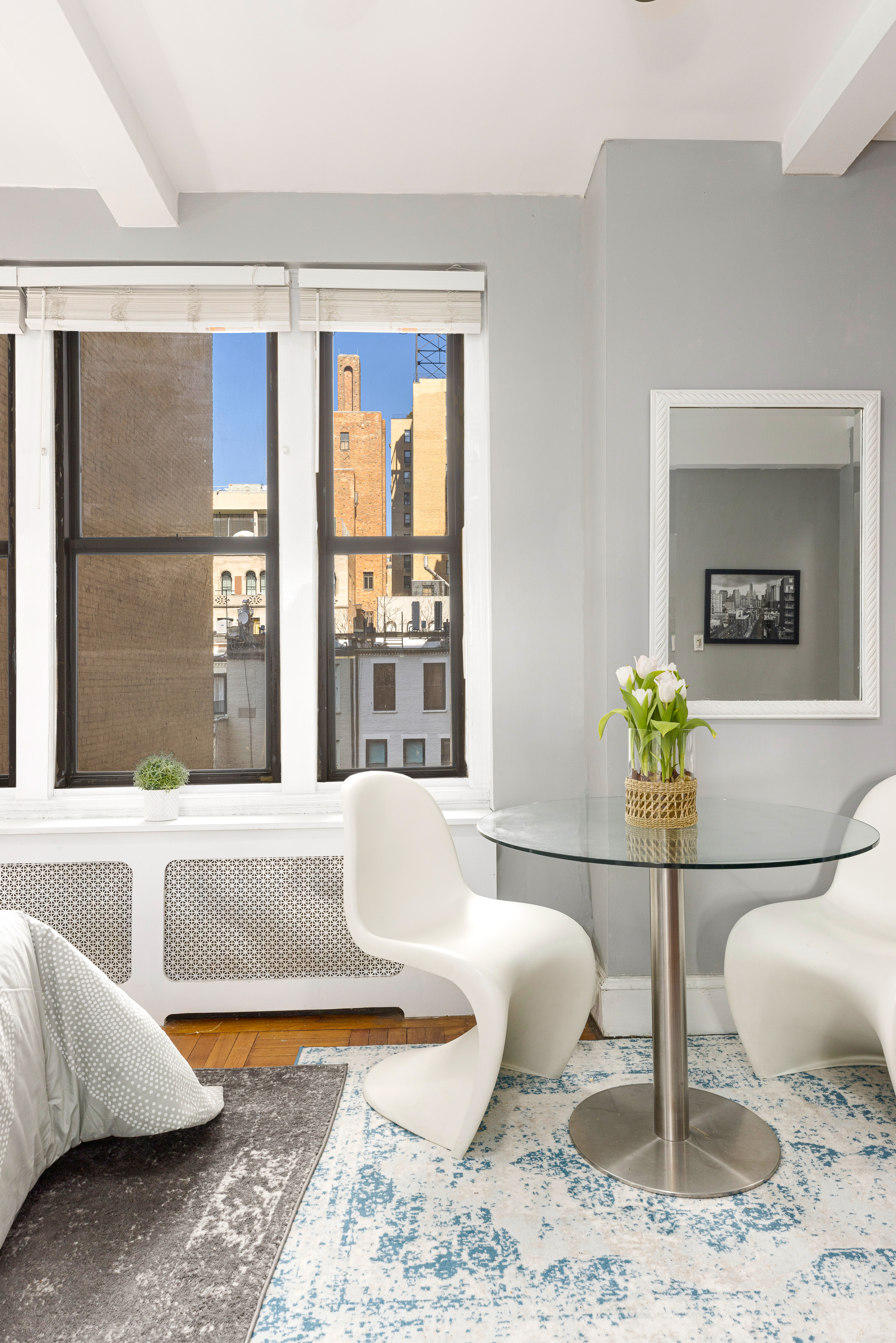 a living room with a couch and a potted plant
