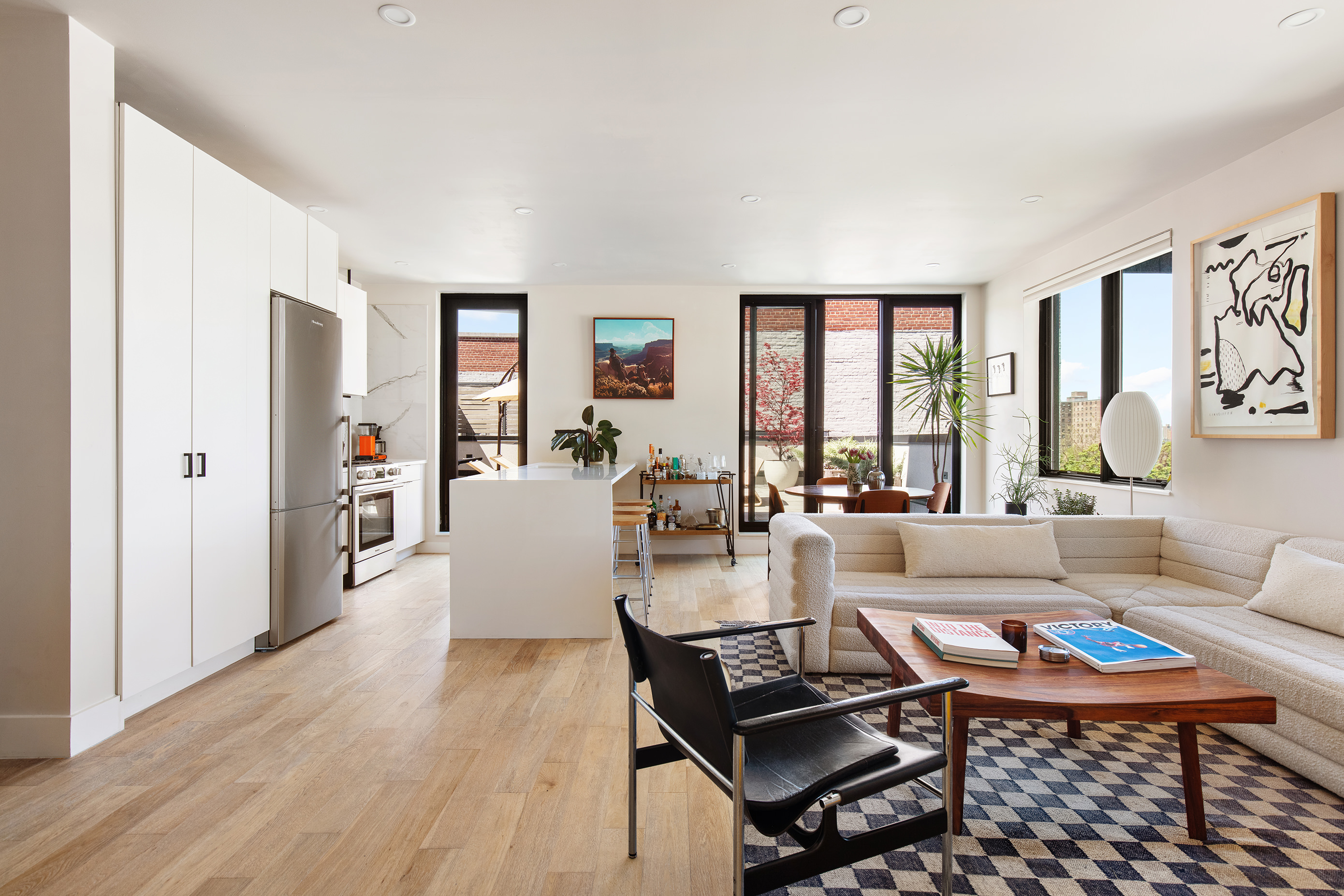 707 Willoughby Avenue, Unit 6B Brooklyn, NY 11206 - Photo 4 of 17 a living room with furniture a large window and wooden floor