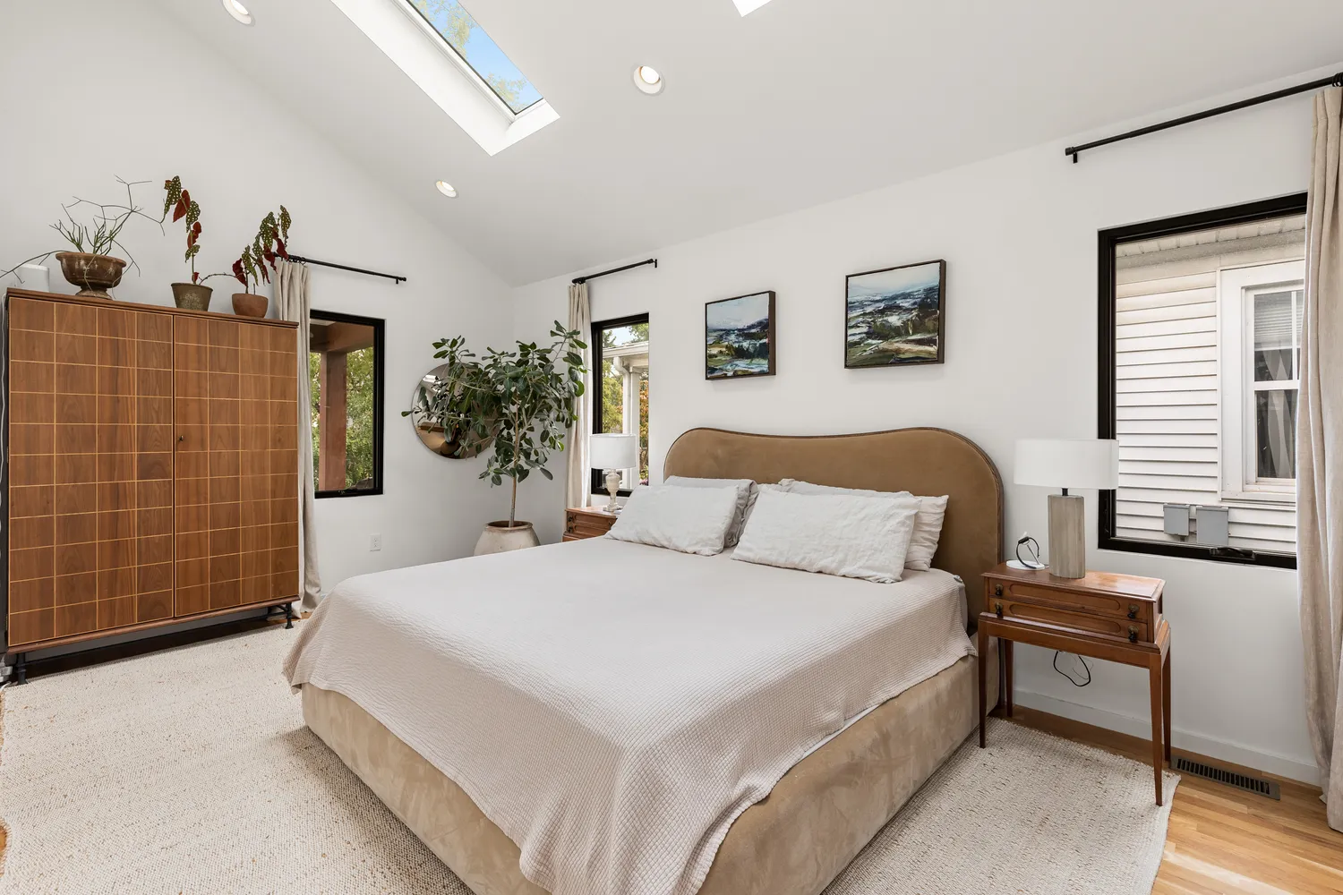 a spacious bedroom with a bed and a couch