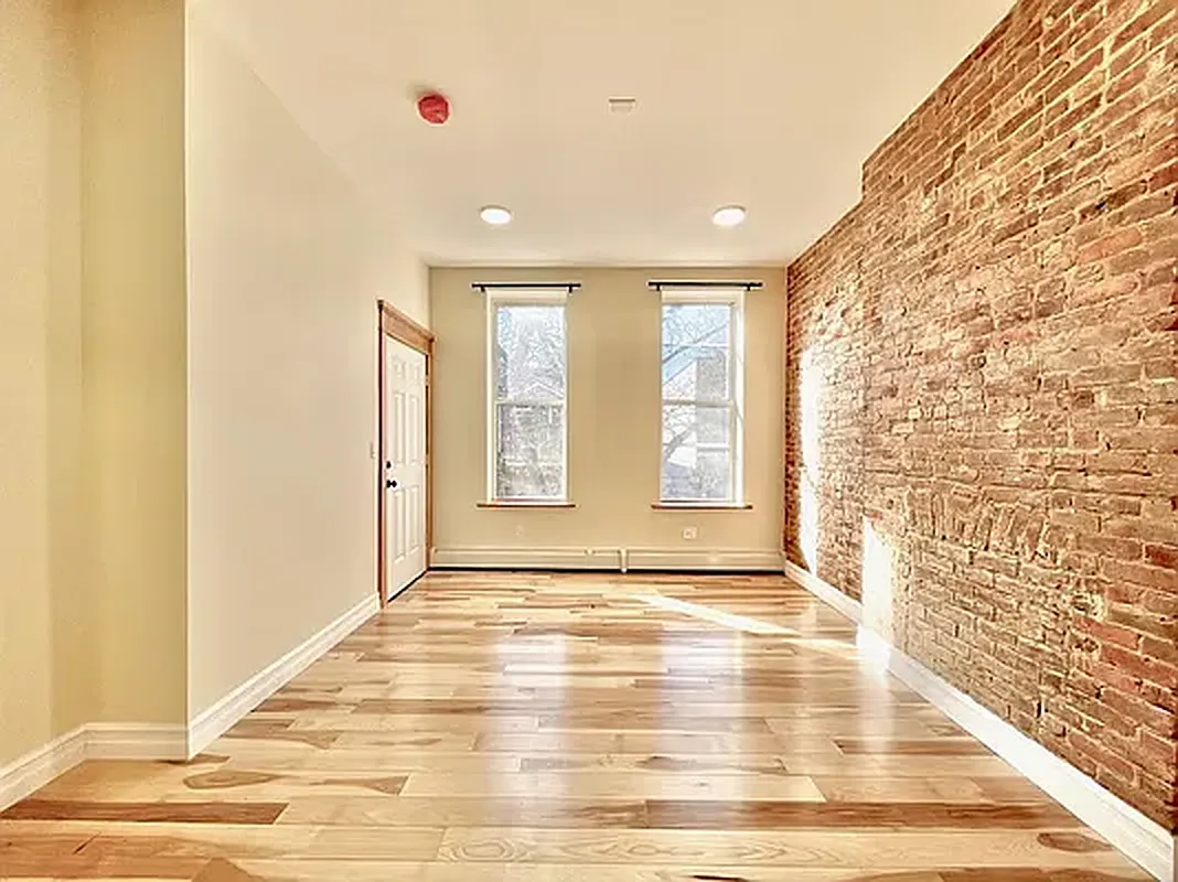 1120 Greene Avenue, Unit 1 Brooklyn, NY 11221 - Photo 10 of 13 a view of an empty room with window and wooden floor