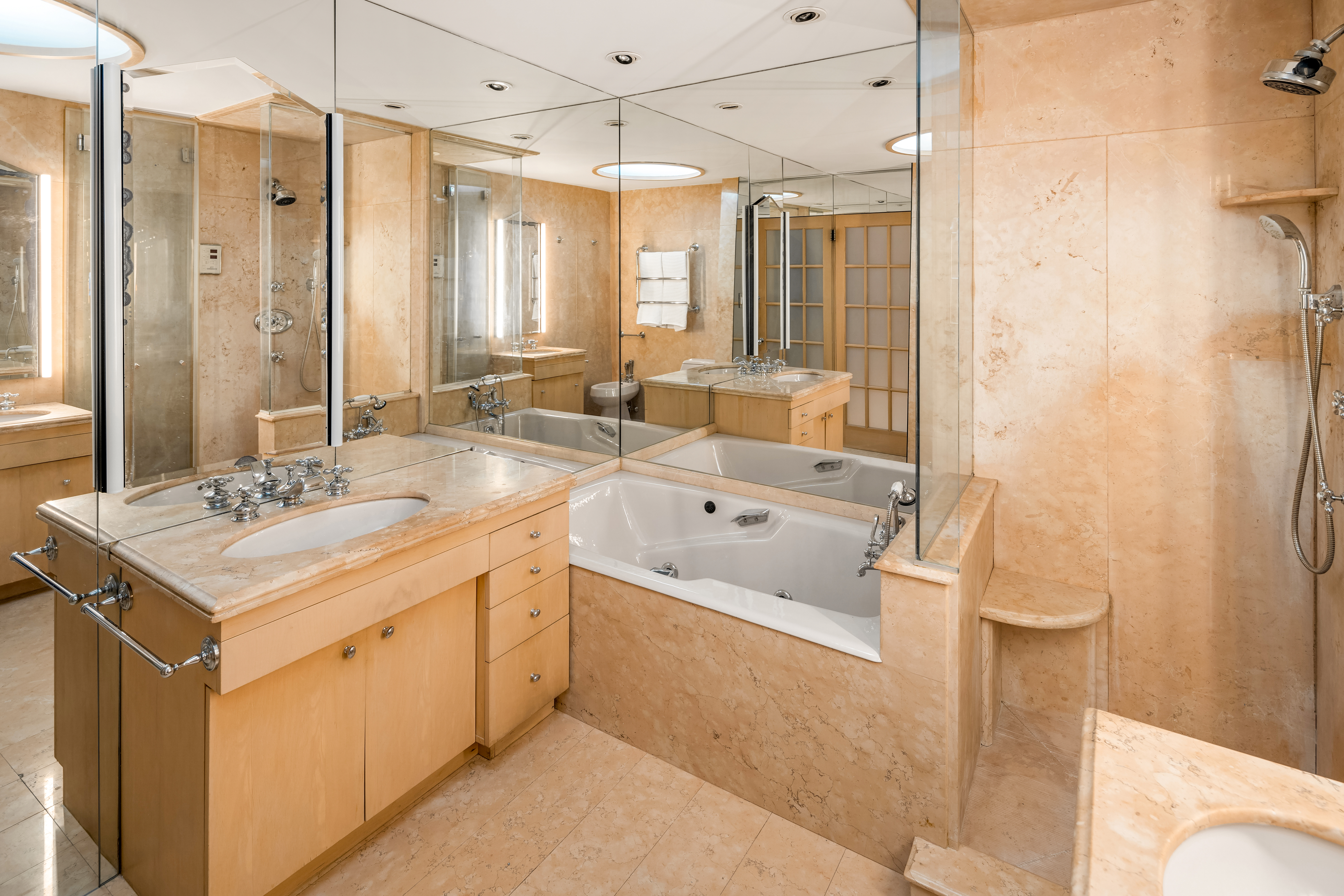 131 Mercer Street, Unit 2B Manhattan, NY 10012 - Photo 12 of 18 a bathroom with a double vanity sink mirror and shower