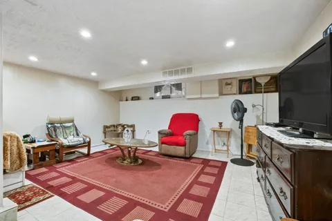 a bedroom with furniture and a flat screen tv
