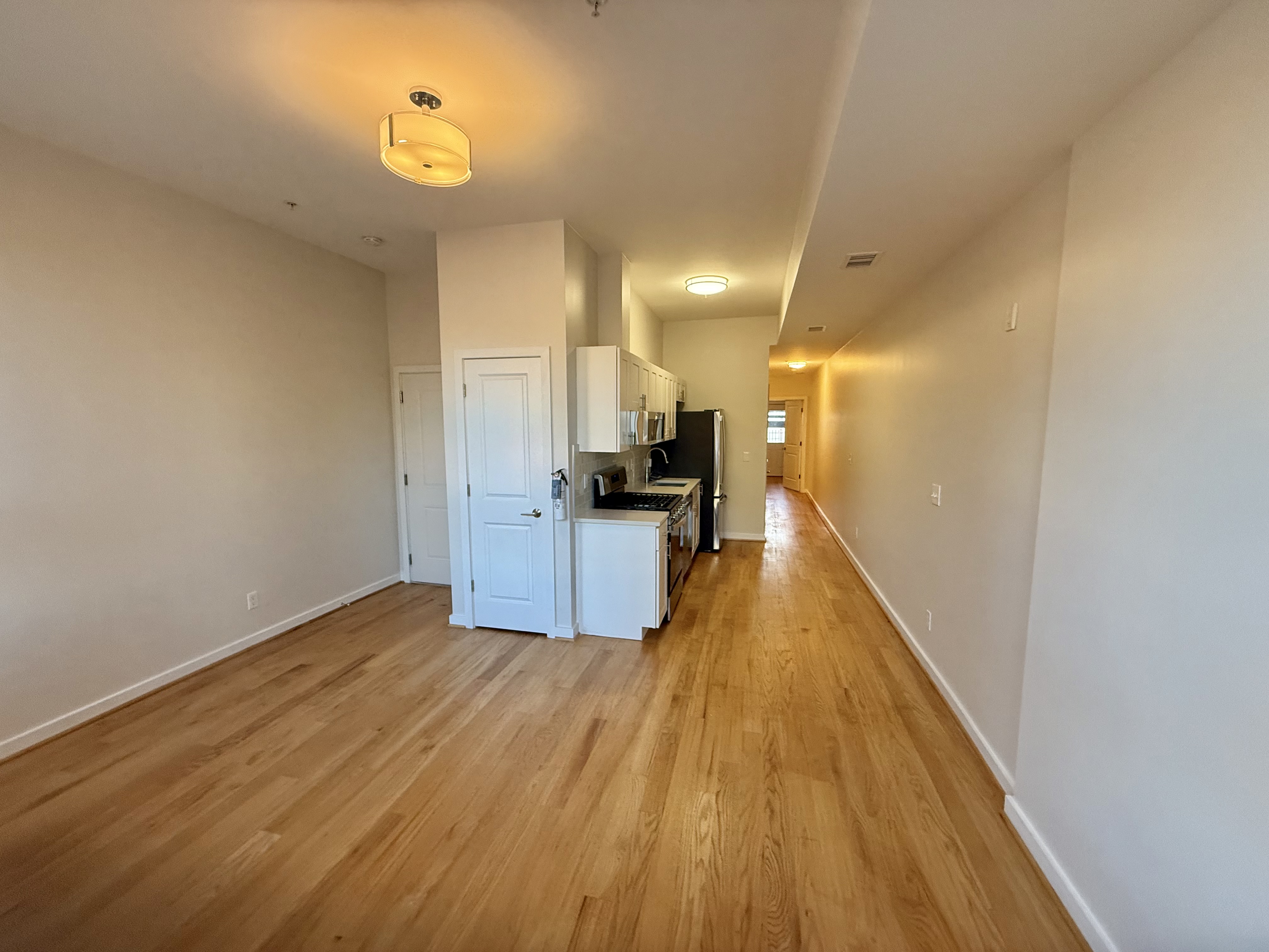 2009 Benning Road Northeast, Unit 2 Washington, DC 20002 - Photo 2 of 11 a view of a kitchen with a sink and wooden floor