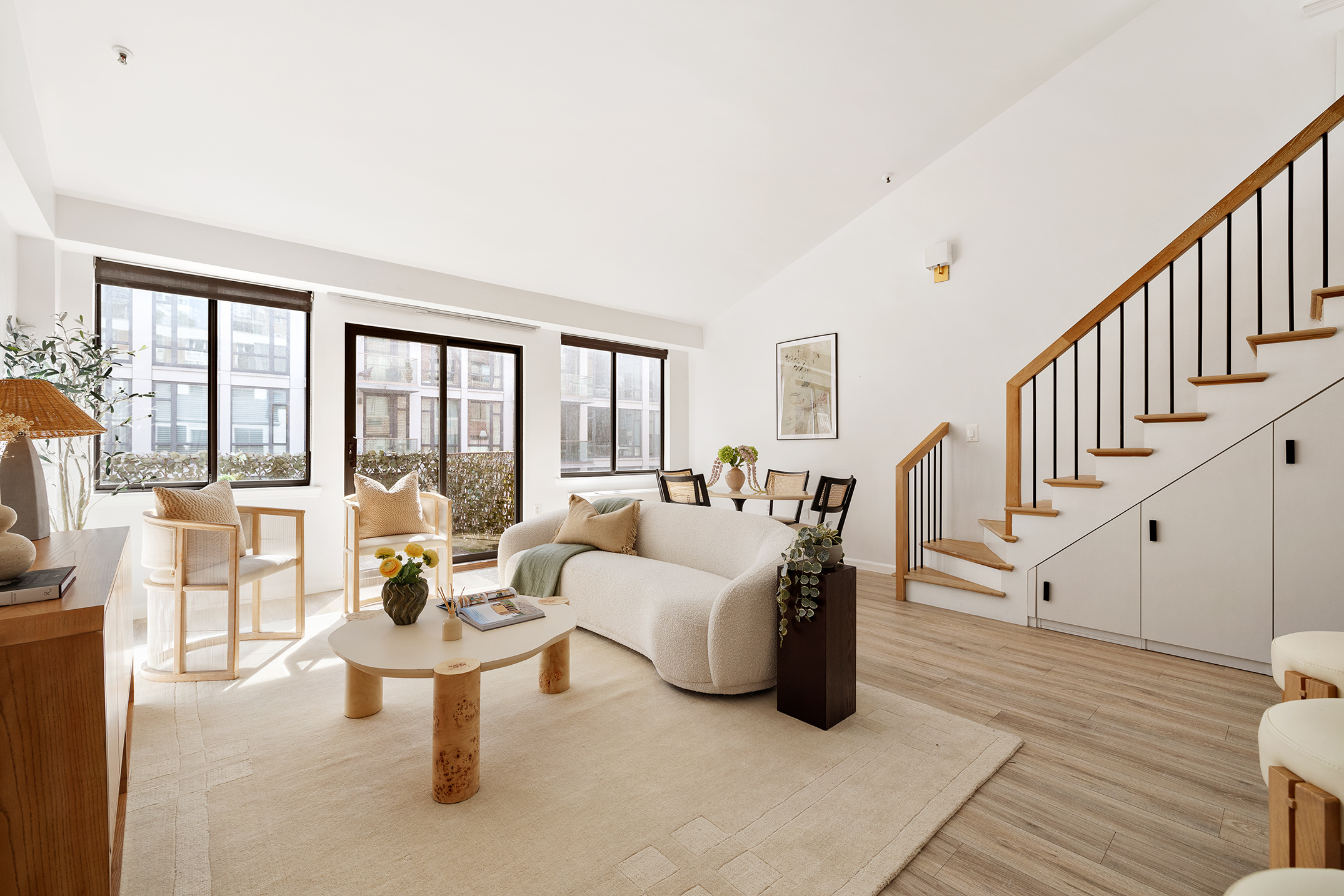 136-140 West 23rd Street, Unit PHD Manhattan, NY 10011 - Photo 3 of 15 a living room with furniture and a table with wooden floor