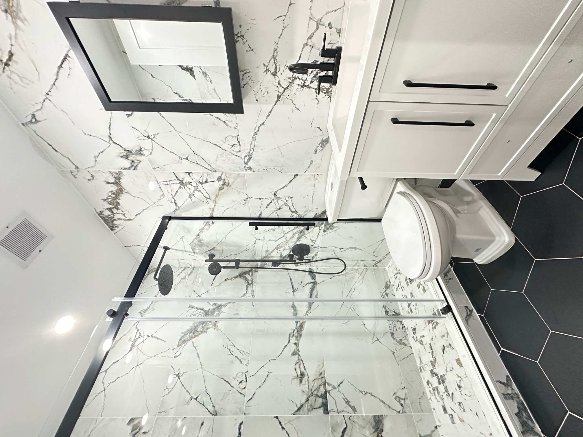 38-18 32nd Street, Unit 1 Queens, NY 11101 - Photo 5 of 6 a bathroom with a granite countertop sink toilet and shower