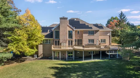 a view of a house with backyard porch and sitting area