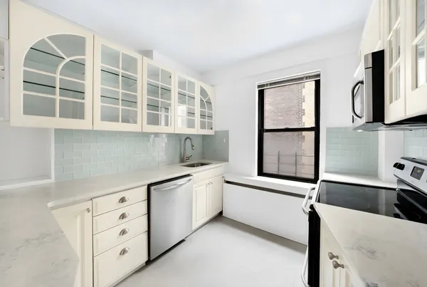 a kitchen with stainless steel appliances granite countertop a sink and a stove