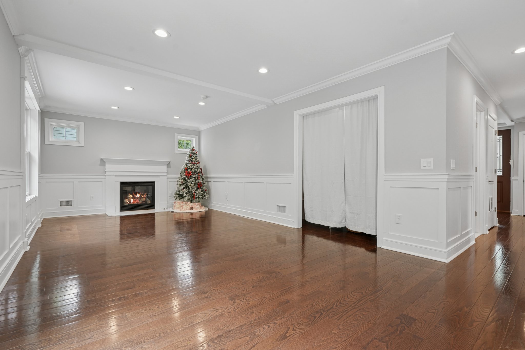 823 River Road Chatham, NJ 07928 - Photo 7 of 60 an empty room with wooden floor fireplace and windows