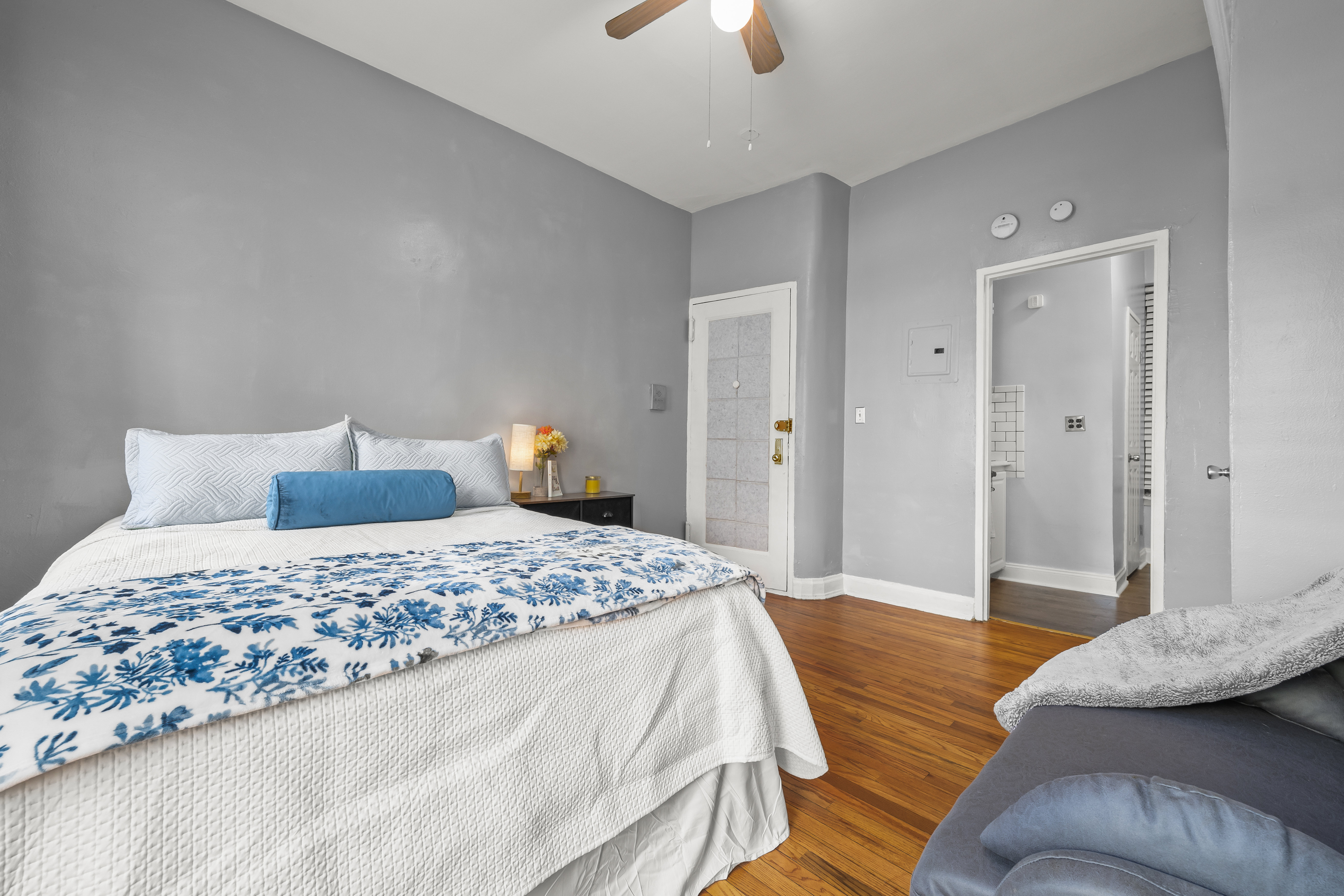 1777 Madison Avenue, Unit 24 Manhattan, NY 10035 - Photo 9 of 20 a bedroom with a bed and a chandelier