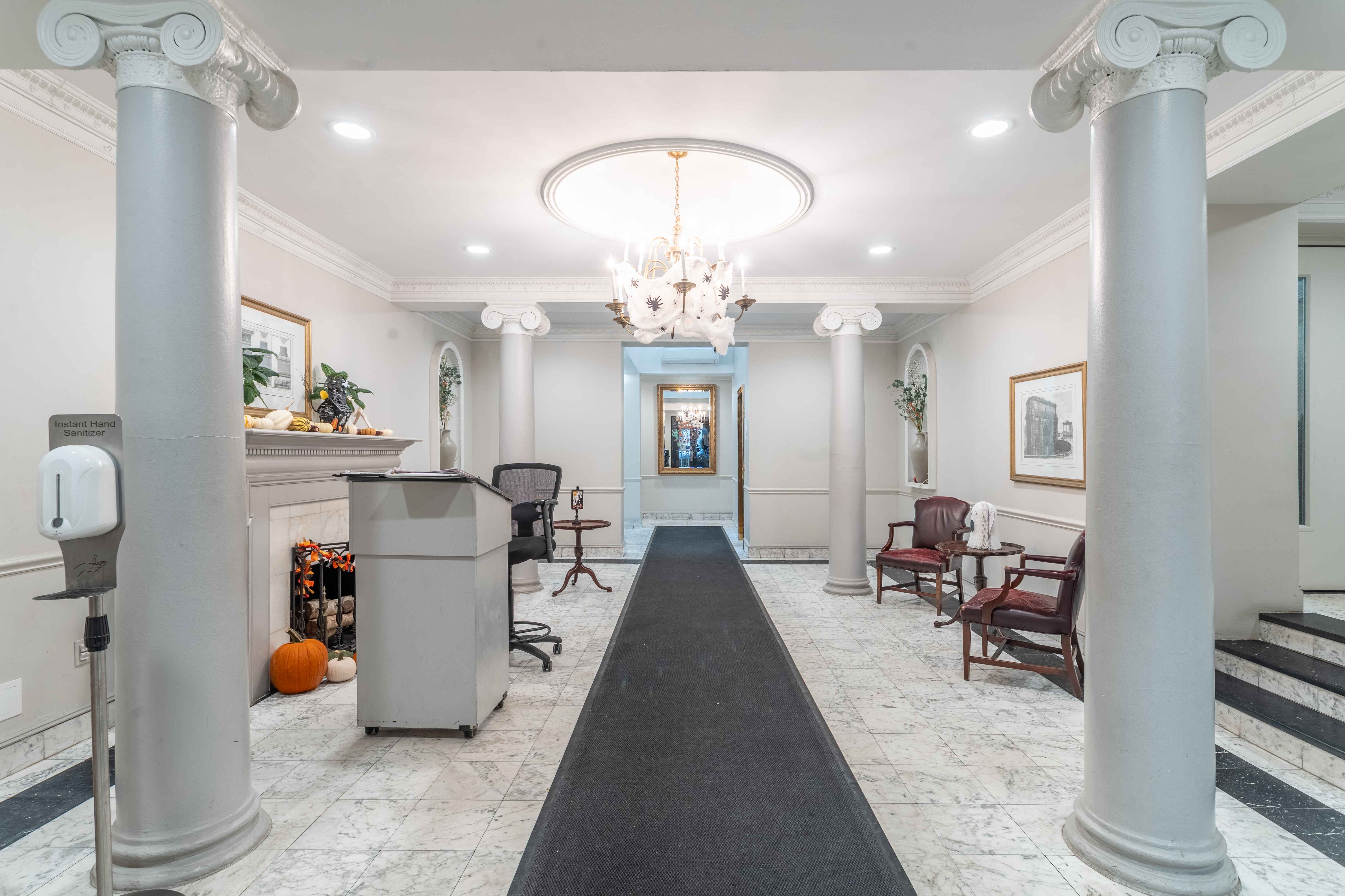 250 West 88th Street, Unit 408 Manhattan, NY 10024 - Photo 8 of 10 a living room with furniture a chandelier and a chandelier