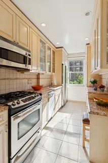 a kitchen with stainless steel appliances granite countertop a stove and a sink