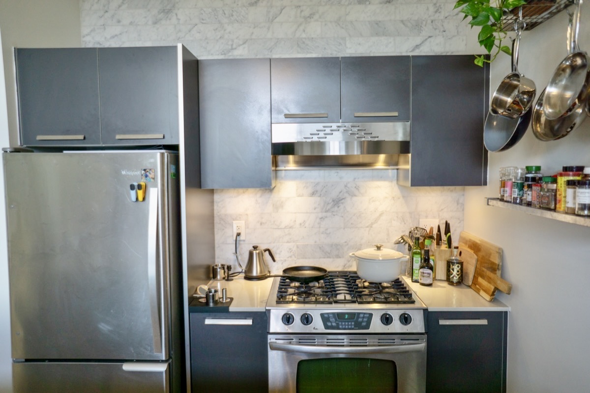2426 Ontario Road Northwest, Unit 401 Washington, DC 20009 - Photo 11 of 28 a kitchen with stainless steel appliances granite countertop a refrigerator and a stove